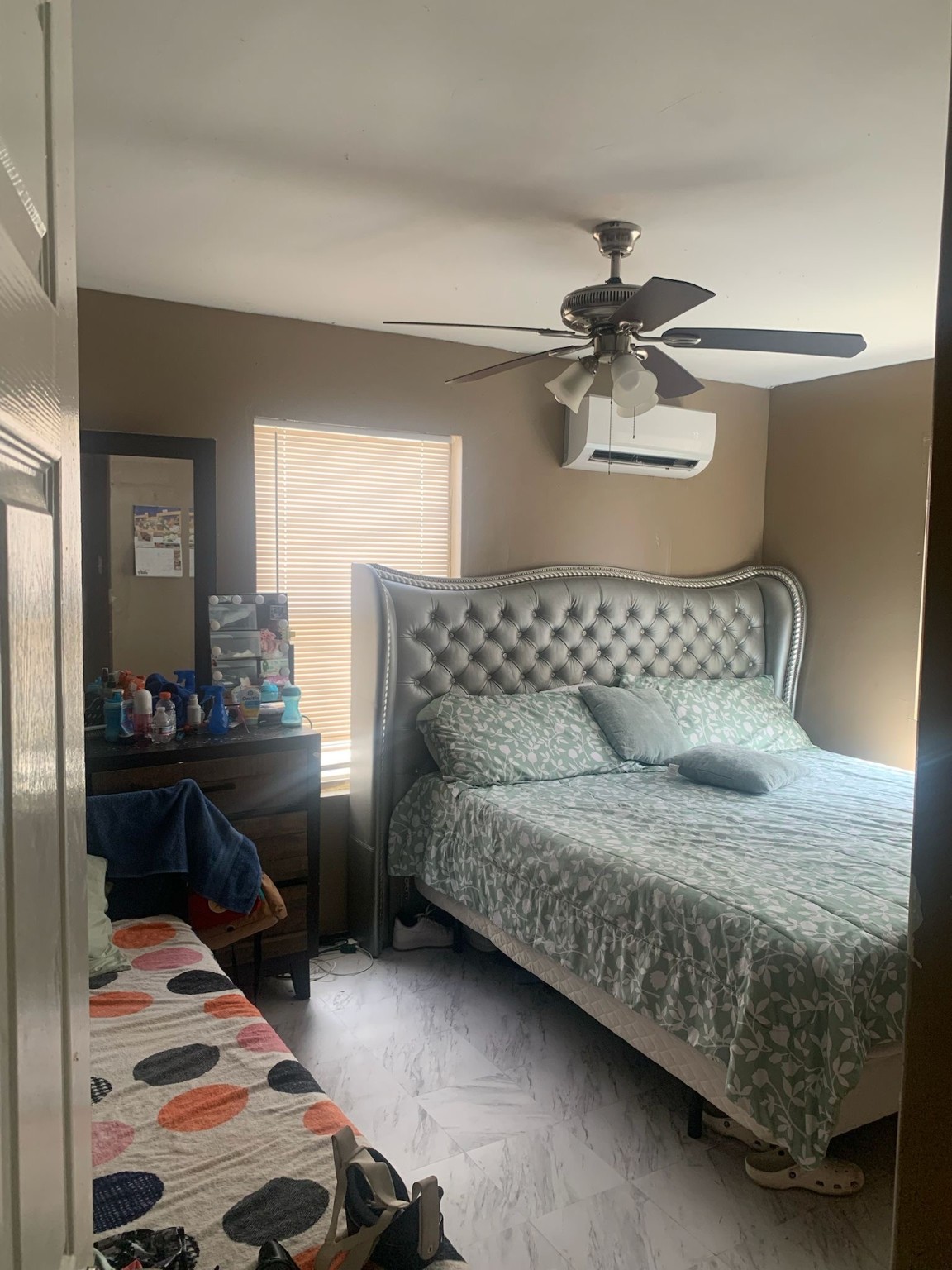 7311 Roswell Street Houston, TX 77022 - Photo 16 of 18 a bedroom with a bed and dresser with mirror