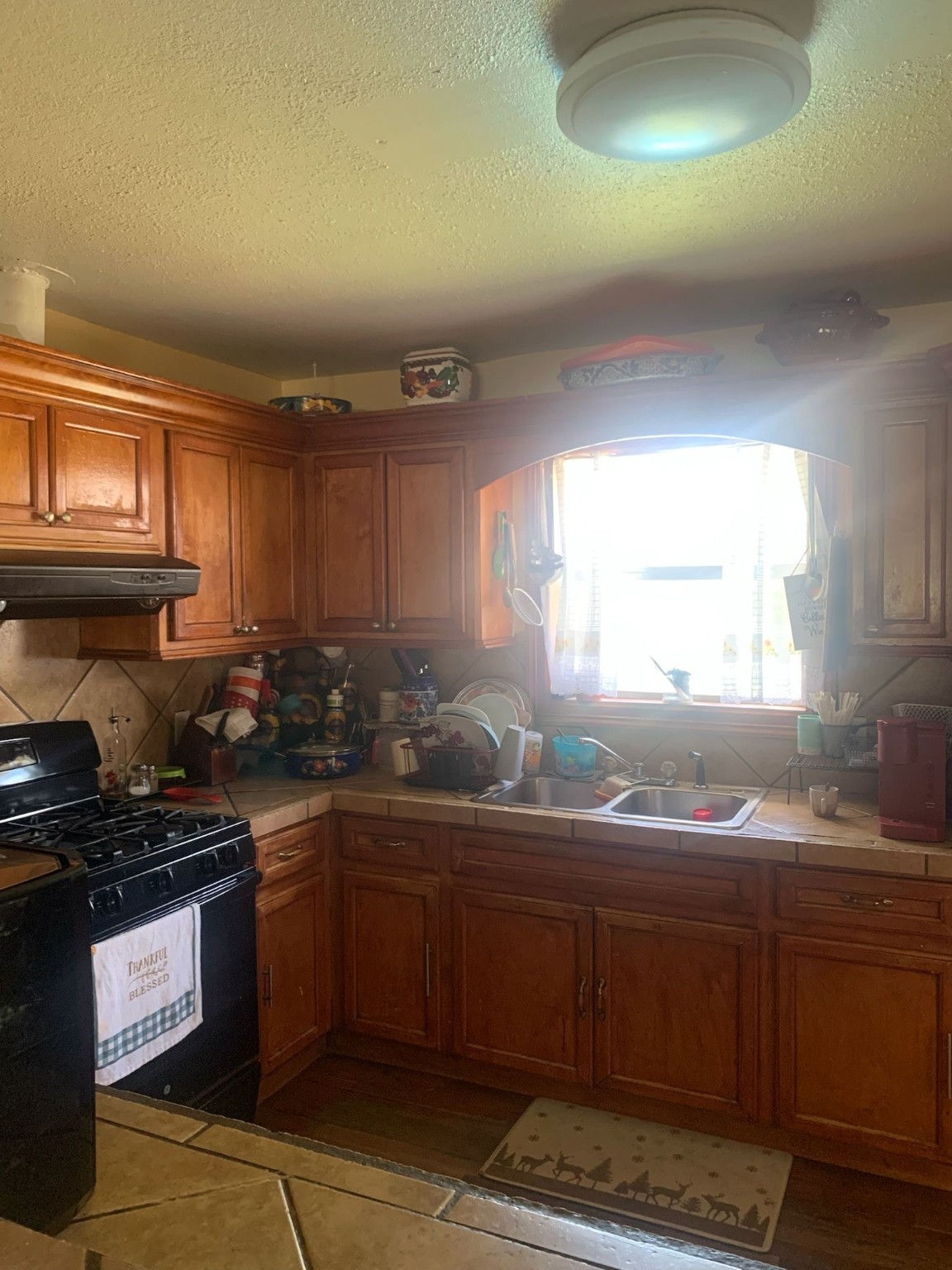 7311 Roswell Street Houston, TX 77022 - Photo 9 of 18 a kitchen with granite countertop a sink a stove and cabinets
