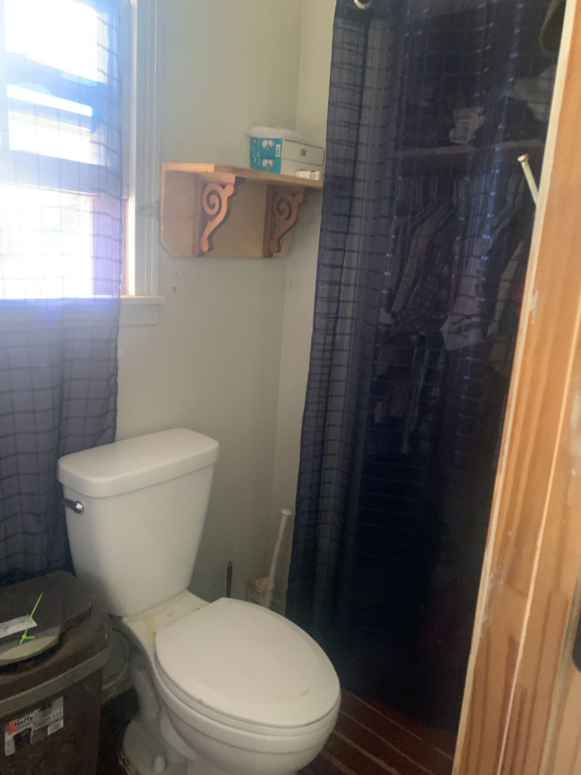 7311 Roswell Street Houston, TX 77022 - Photo 10 of 18 a white toilet sitting next to a shower