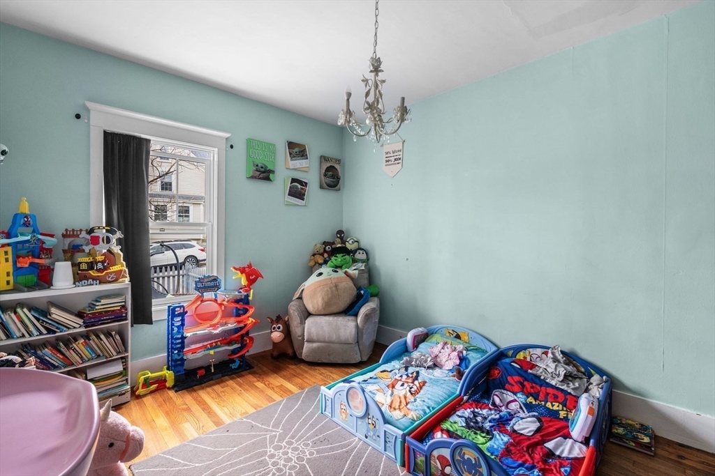 149 Elm Street Marblehead, MA 01945 - Photo 11 of 41 a bedroom with bed and wooden floor