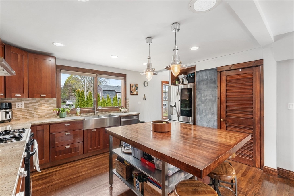 149 Elm Street Marblehead, MA 01945 - Photo 20 of 41 a kitchen with a table chairs sink and wooden floor