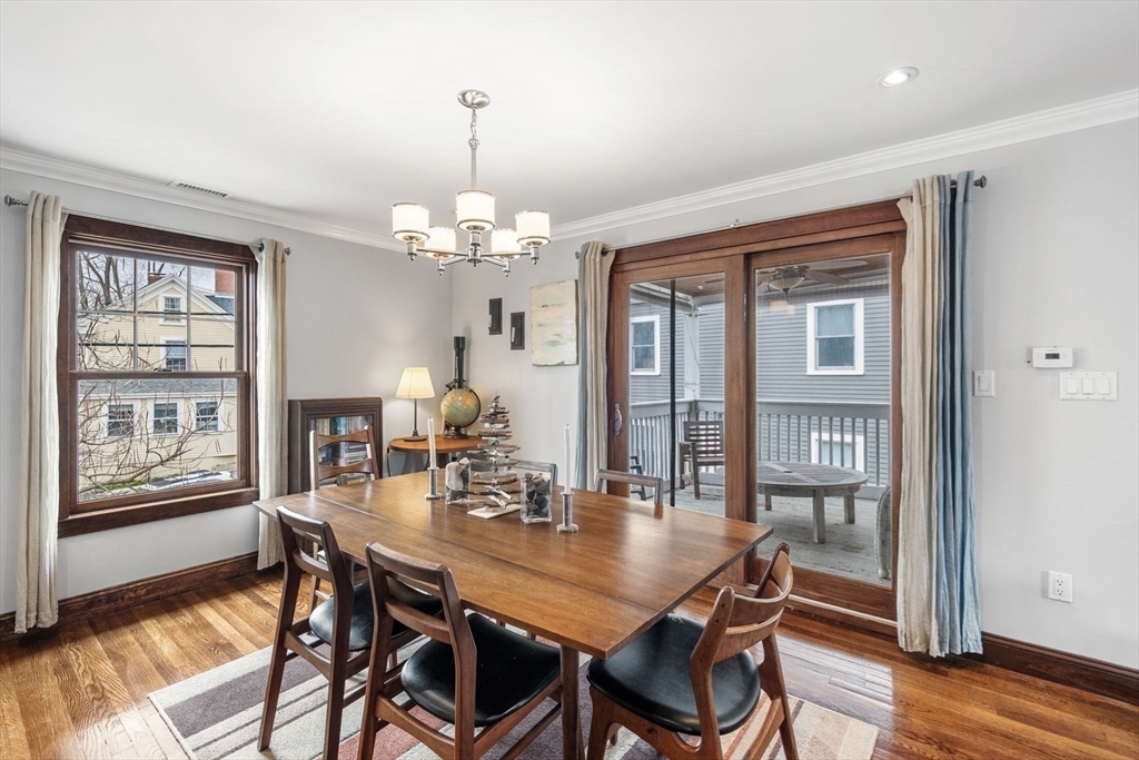 149 Elm Street Marblehead, MA 01945 - Photo 23 of 41 a view of a dining room with furniture wooden floor and chandelier
