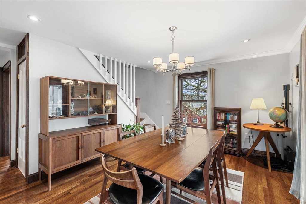 149 Elm Street Marblehead, MA 01945 - Photo 24 of 41 a view of a dining room with furniture a chandelier and wooden floor