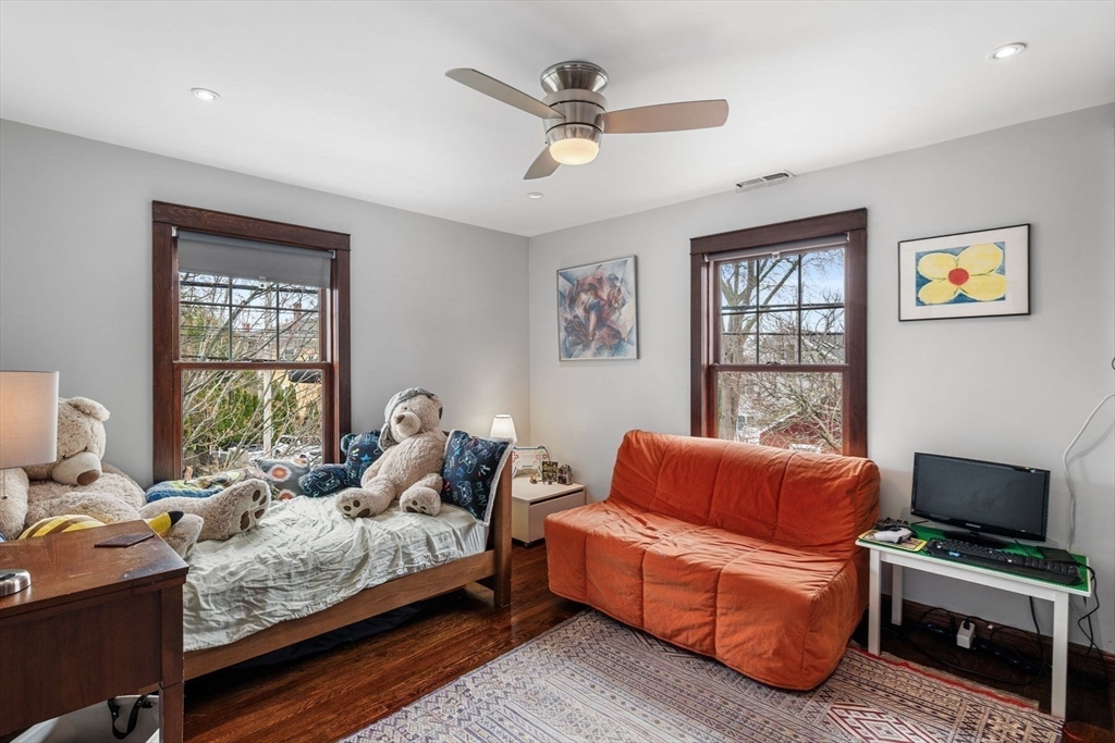 149 Elm Street Marblehead, MA 01945 - Photo 25 of 41 a living room with furniture ceiling fan and a window
