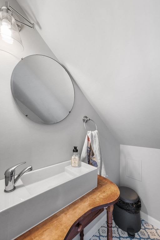 149 Elm Street Marblehead, MA 01945 - Photo 28 of 41 a bathroom with a sink and a mirror
