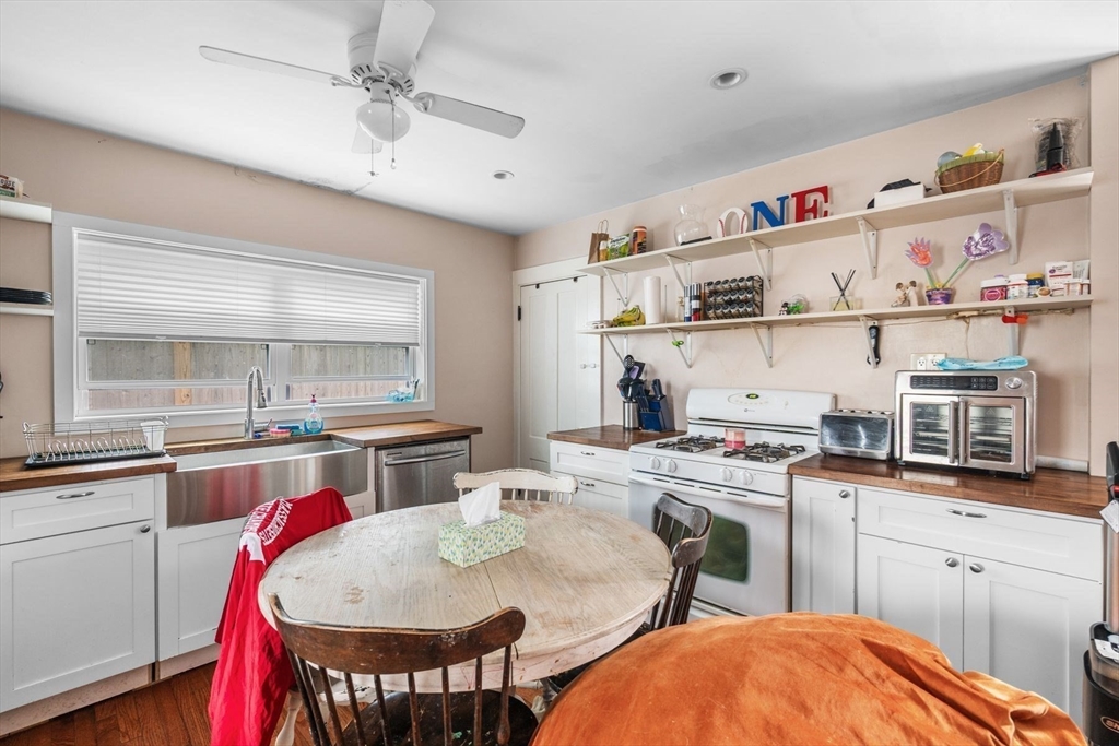 149 Elm Street Marblehead, MA 01945 - Photo 8 of 41 a open kitchen with stainless steel appliances granite countertop a stove a sink and a refrigerator