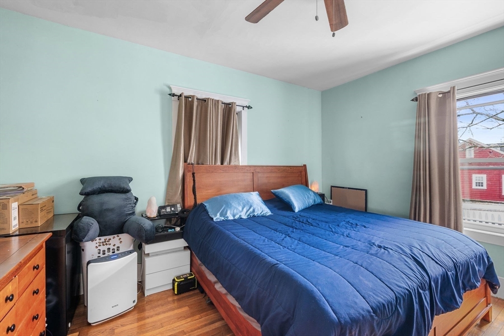 149 Elm Street Marblehead, MA 01945 - Photo 9 of 41 a bedroom with a bed and wooden floor