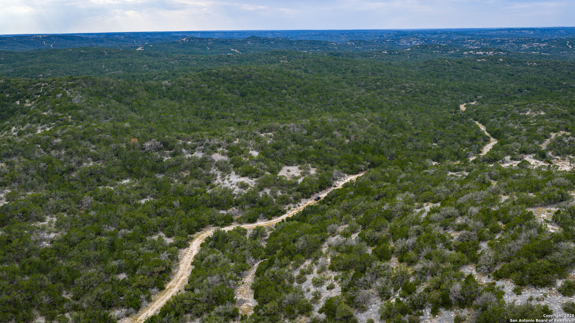 Tbd Tbd Rocksprings, TX 78880 - Photo 32 of 33 a view of a lush green forest with trees and some houses