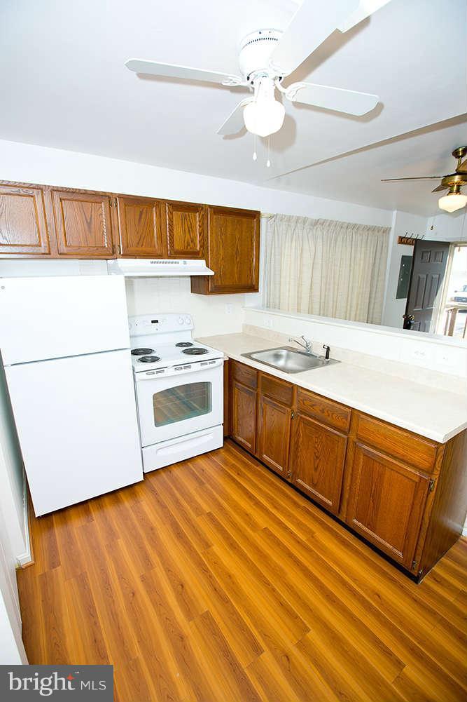 1634 Elkridge Drive Edgewater, MD 21037 - Photo 5 of 13 a kitchen with stainless steel appliances granite countertop a sink a stove counter space and cabinets