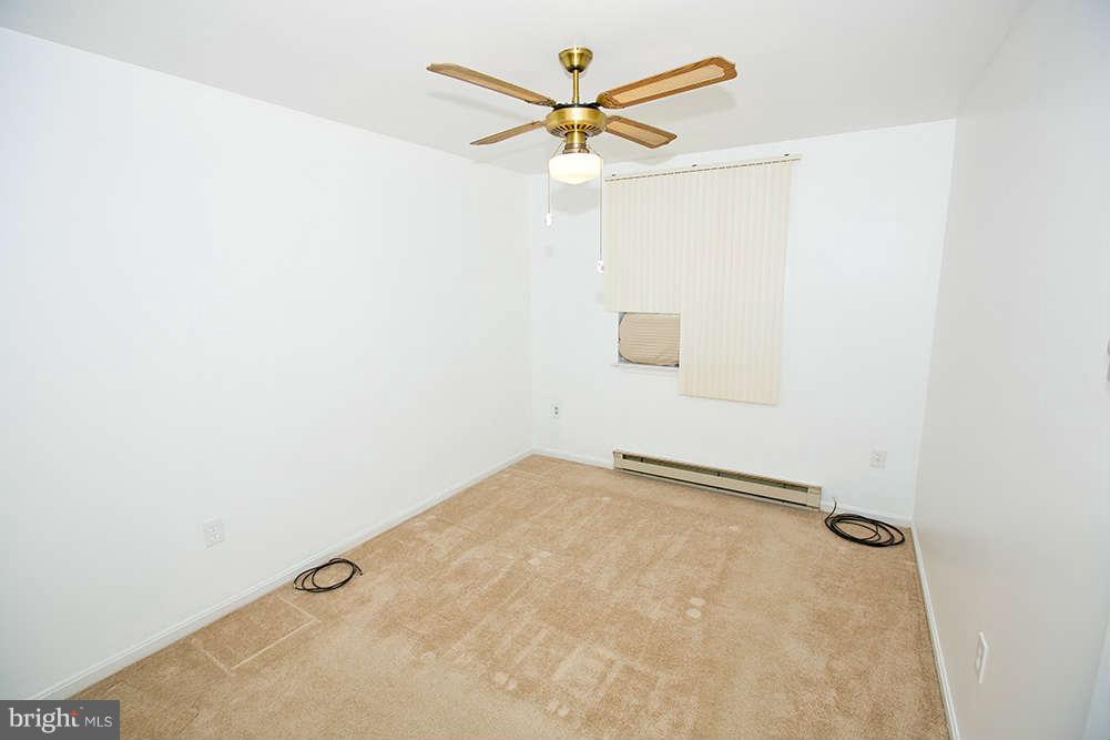 1634 Elkridge Drive Edgewater, MD 21037 - Photo 8 of 13 an empty room with a ceiling fan and a window