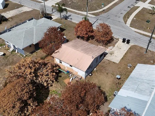 an aerial view of a house with a yard