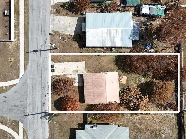 aerial view of a house with a yard