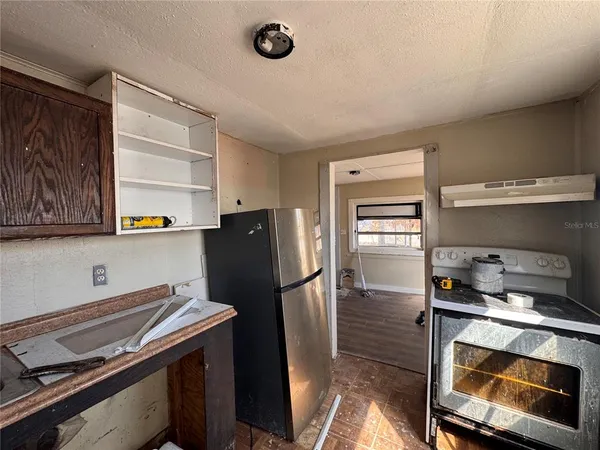 a kitchen with stainless steel appliances a refrigerator and a stove