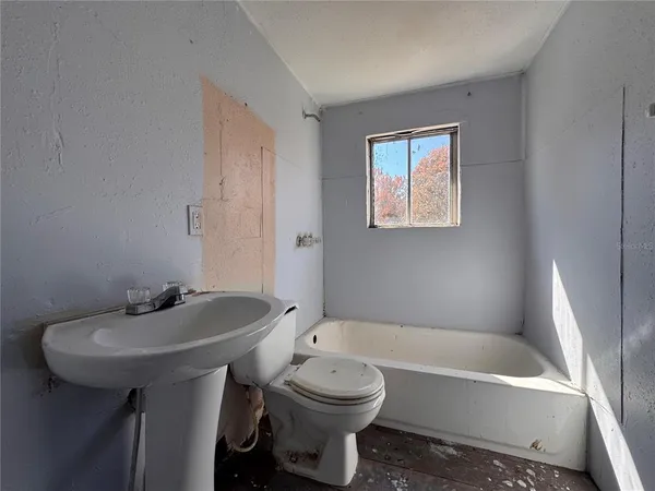 a bathroom with a sink a toilet and bathtub