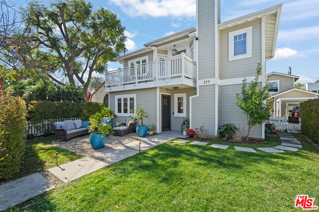 a view of a house with backyard sitting area and garden