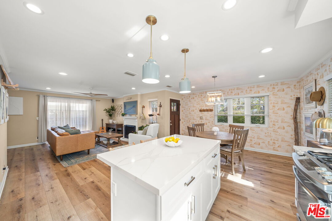 359 Termino Avenue Long Beach, CA 90814 - Photo 11 of 22 a view of a dining room and livingroom with furniture wooden floor a rug a chandelier
