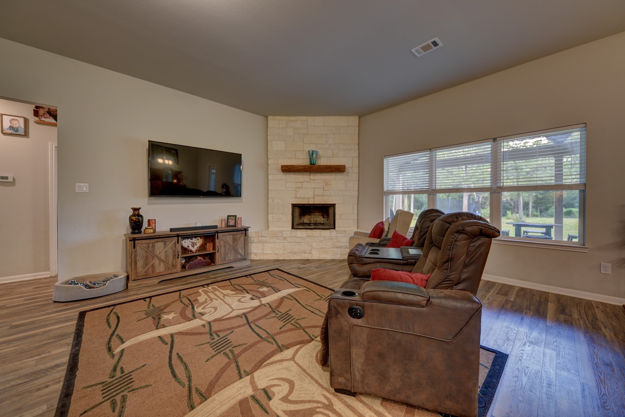 2612 Tiemann Road New Ulm, TX 78950 - Photo 12 of 39 a living room with furniture a flat screen tv and a fireplace