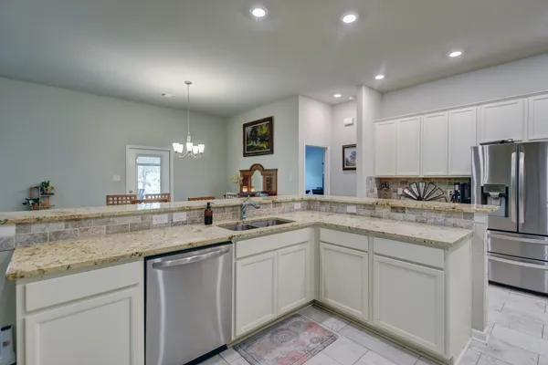 a kitchen with a sink stove and refrigerator