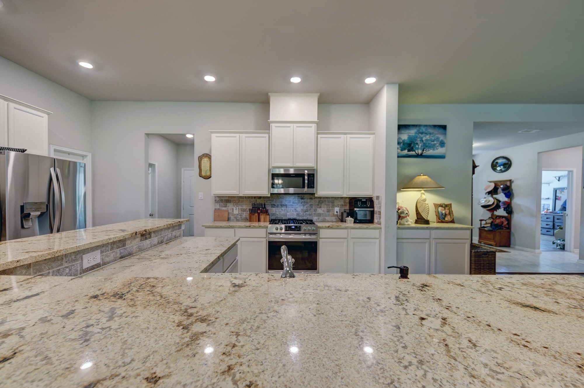 2612 Tiemann Road New Ulm, TX 78950 - Photo 18 of 39 a large kitchen with stainless steel appliances kitchen island granite countertop a large counter top and view of living room