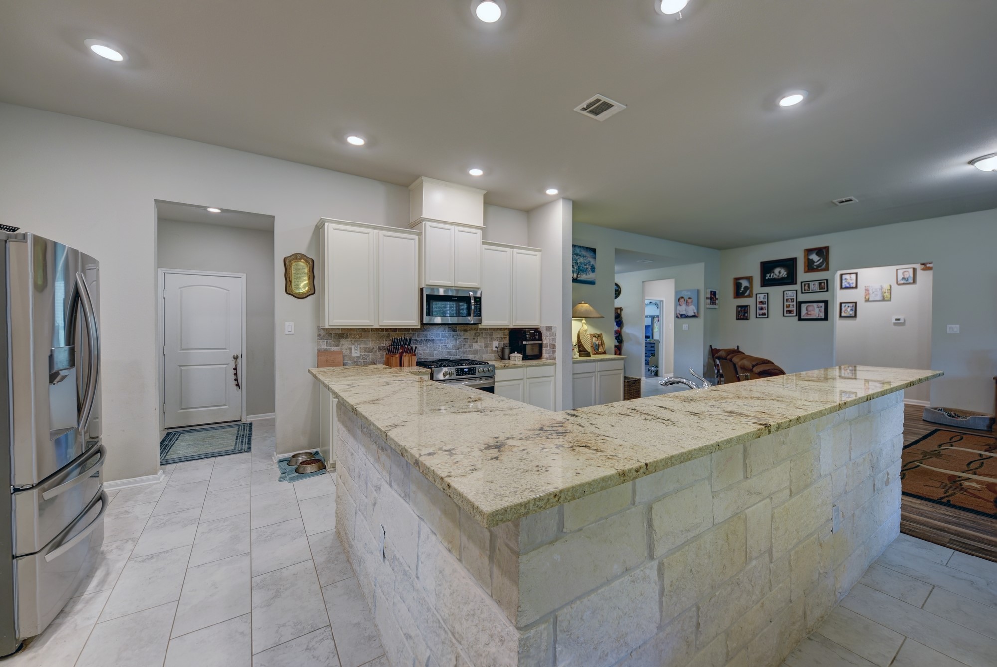 2612 Tiemann Road New Ulm, TX 78950 - Photo 19 of 39 a large kitchen with stainless steel appliances lots of counter space and a sink