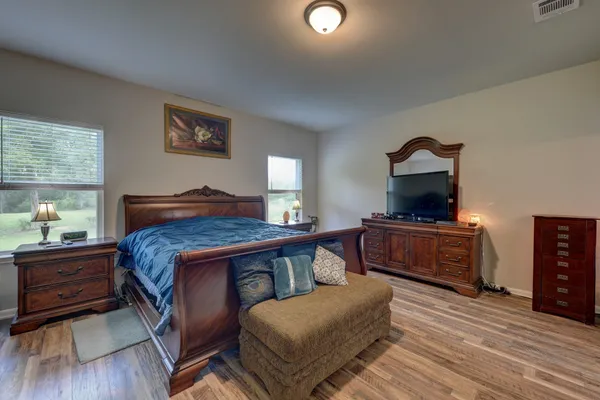 a bedroom with a bed and a dresser