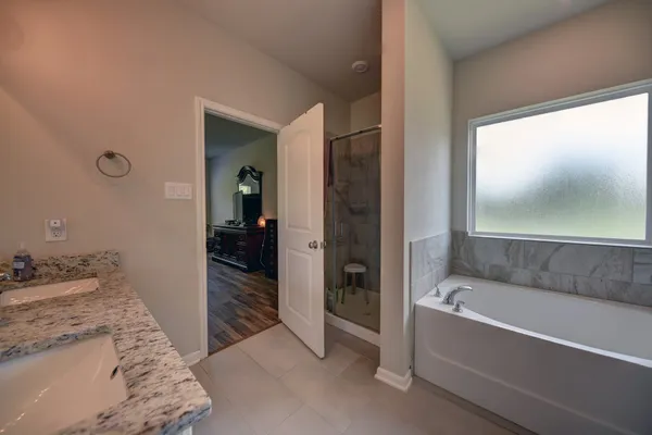 a bathroom with a tub and a sink