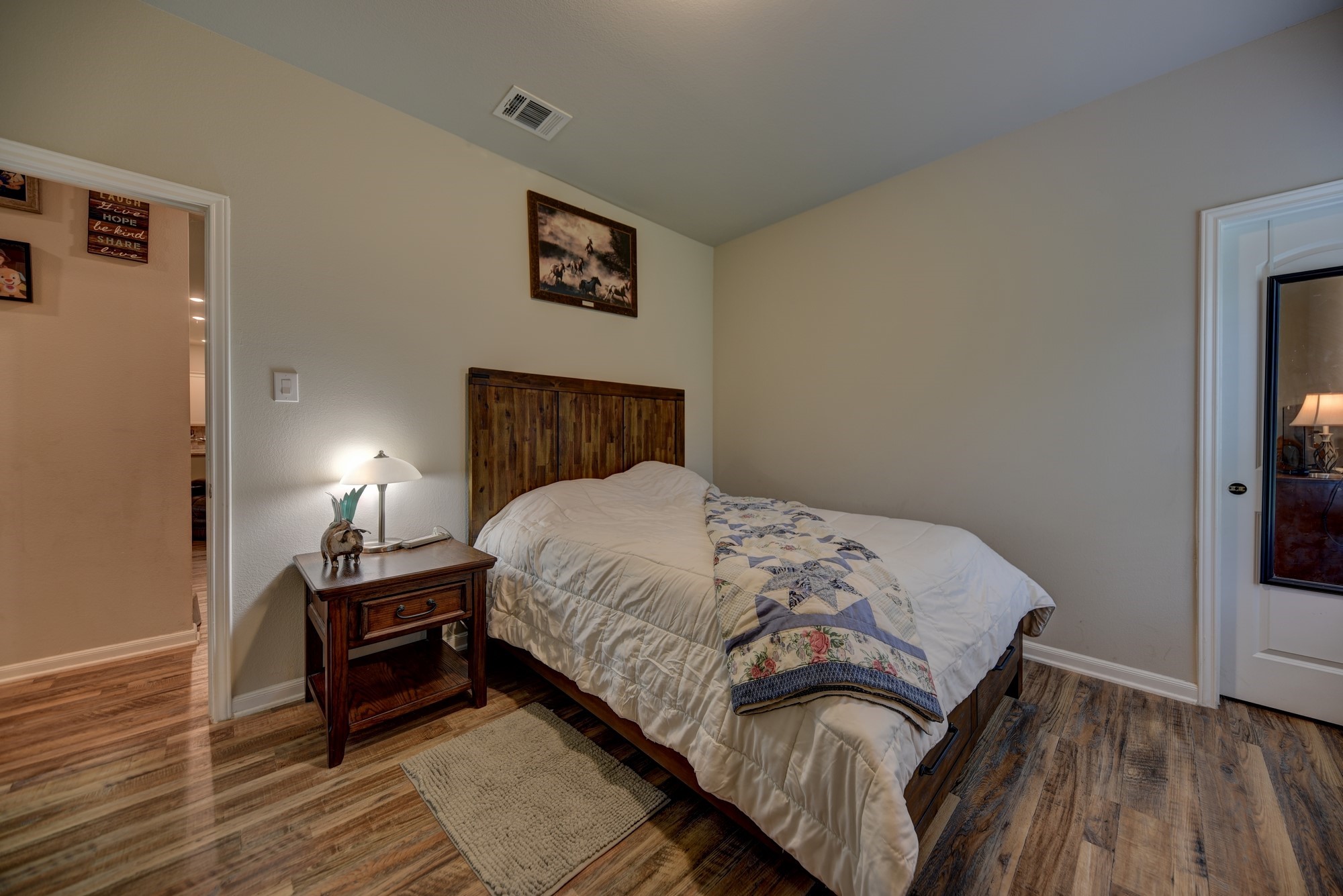 2612 Tiemann Road New Ulm, TX 78950 - Photo 26 of 39 a bedroom with a bed and wooden floor