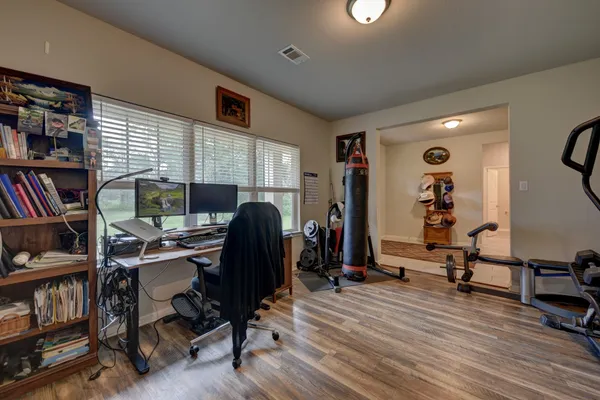 a view of a workspace with furniture and a bookshelf