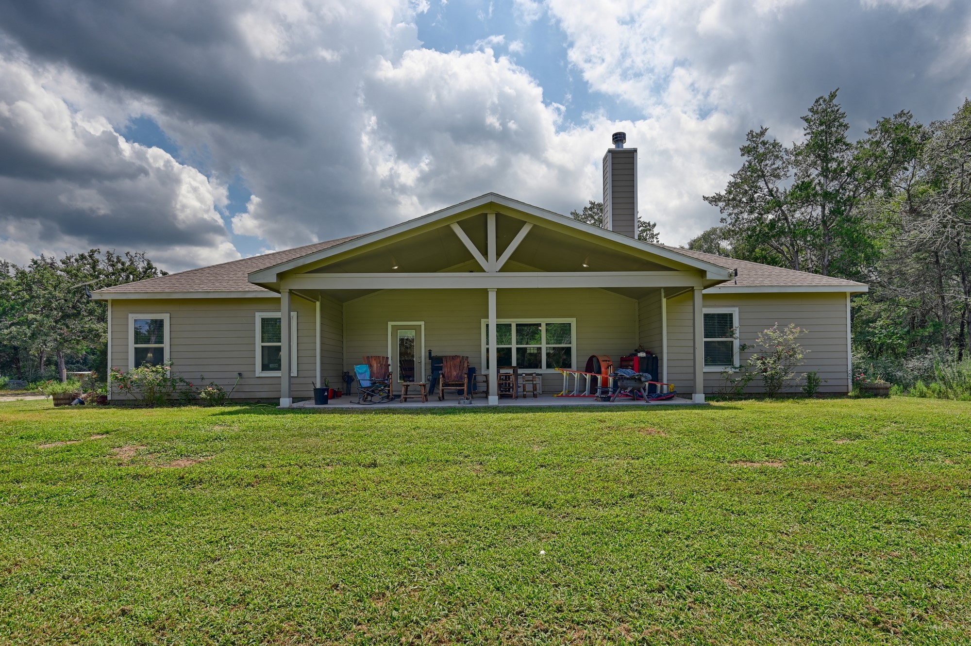 2612 Tiemann Road New Ulm, TX 78950 - Photo 29 of 39 a front view of a house with a yard and trees
