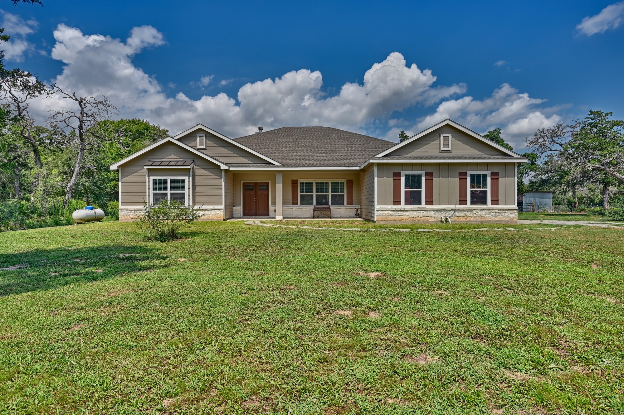 2612 Tiemann Road New Ulm, TX 78950 - Photo 6 of 39 a front view of a house with a garden