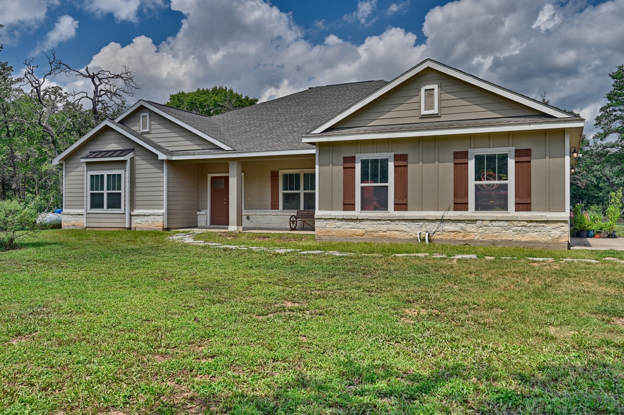 2612 Tiemann Road New Ulm, TX 78950 - Photo 7 of 39 a front view of a house with a garden