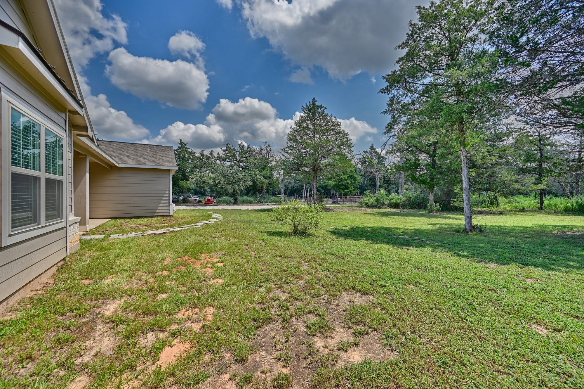 2612 Tiemann Road New Ulm, TX 78950 - Photo 8 of 39 a backyard of a house with lots of green space