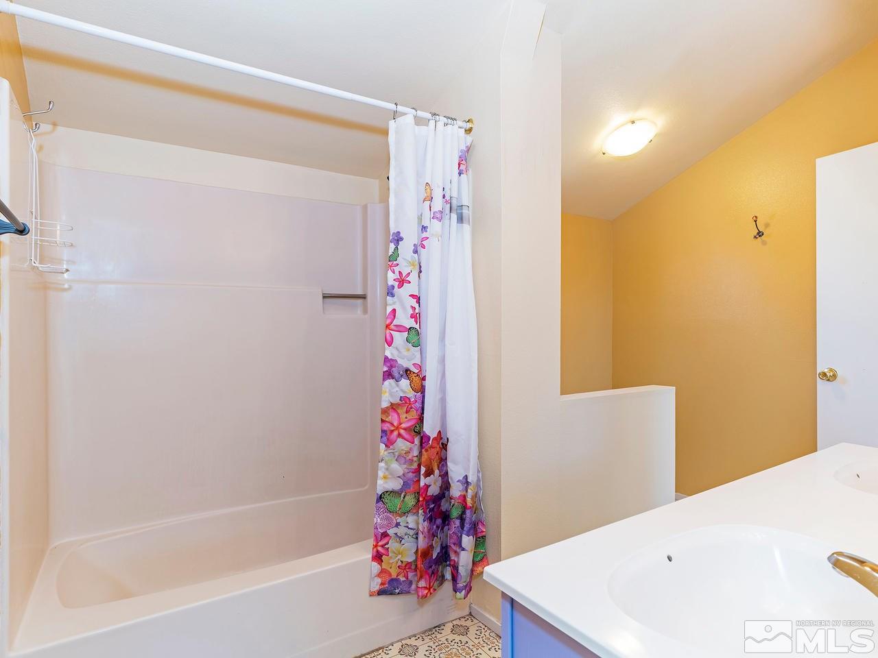320 Caliente Street Reno, NV 89509 - Photo 14 of 17 a bathroom with a bathtub and shower