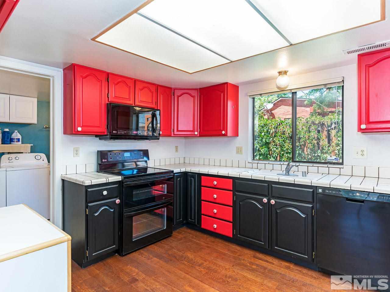 320 Caliente Street Reno, NV 89509 - Photo 10 of 17 a kitchen with stainless steel appliances granite countertop a stove a sink dishwasher a microwave oven with granite countertops and cabinets