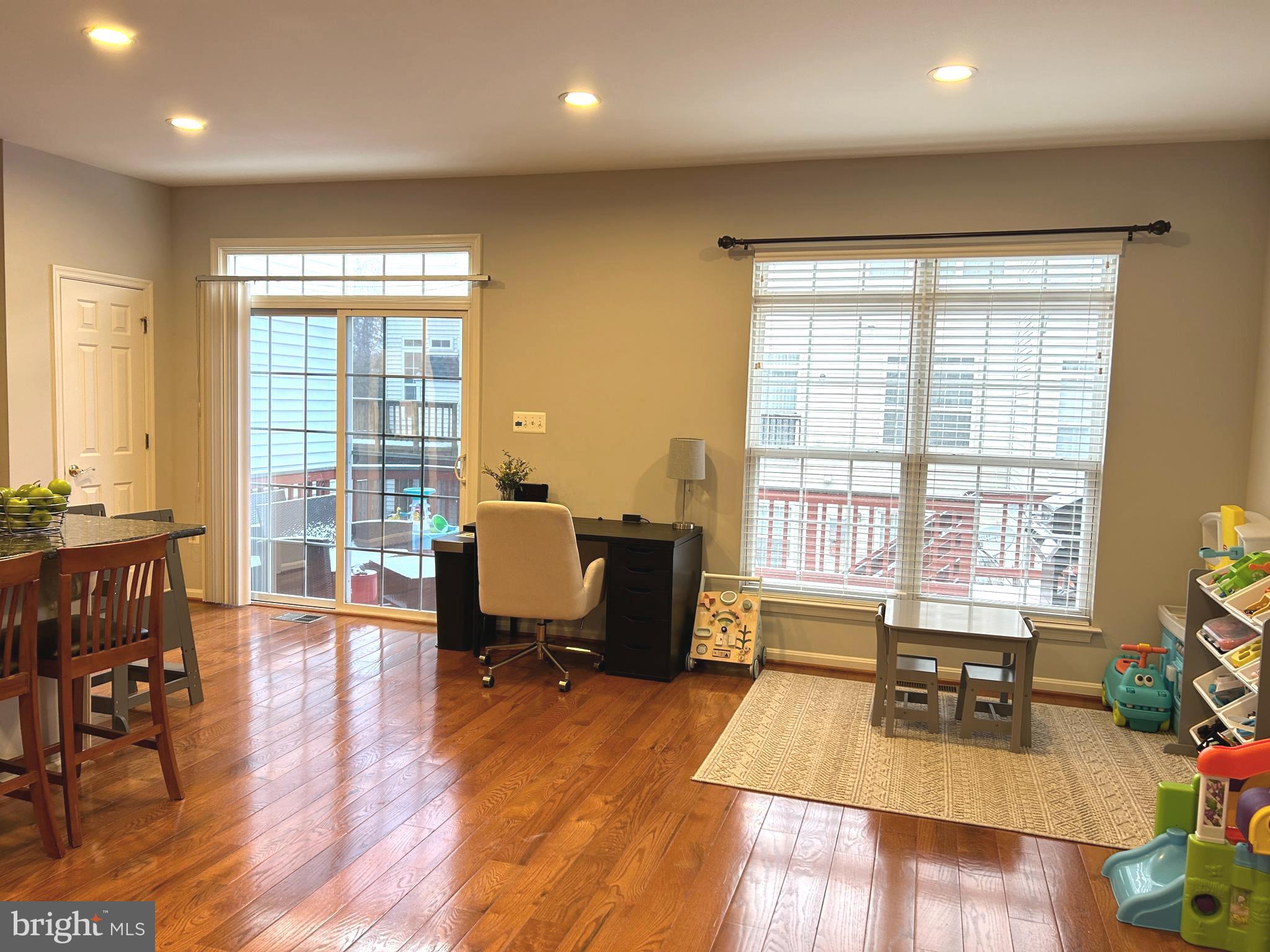 7358 Bloomington Court Springfield, VA 22150 - Photo 20 of 69 a living room with furniture a large window and wooden floor
