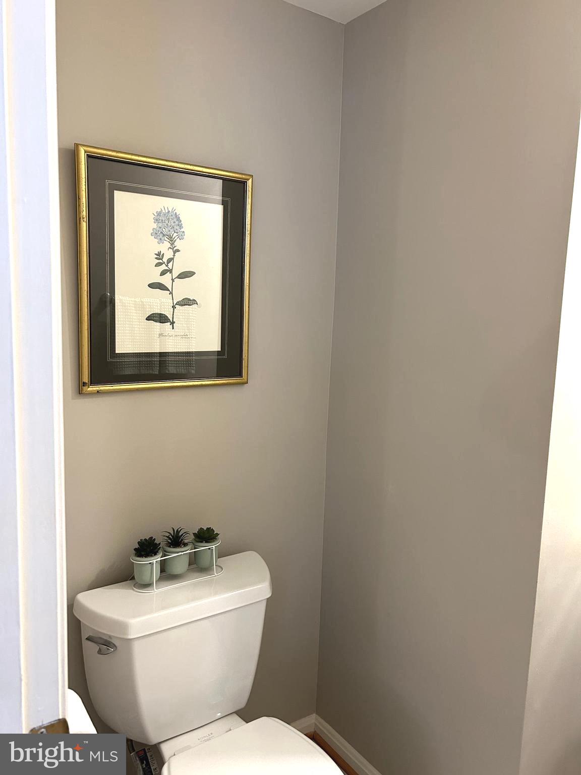 7358 Bloomington Court Springfield, VA 22150 - Photo 24 of 69 a white toilet sitting next to a white sink and a mirror