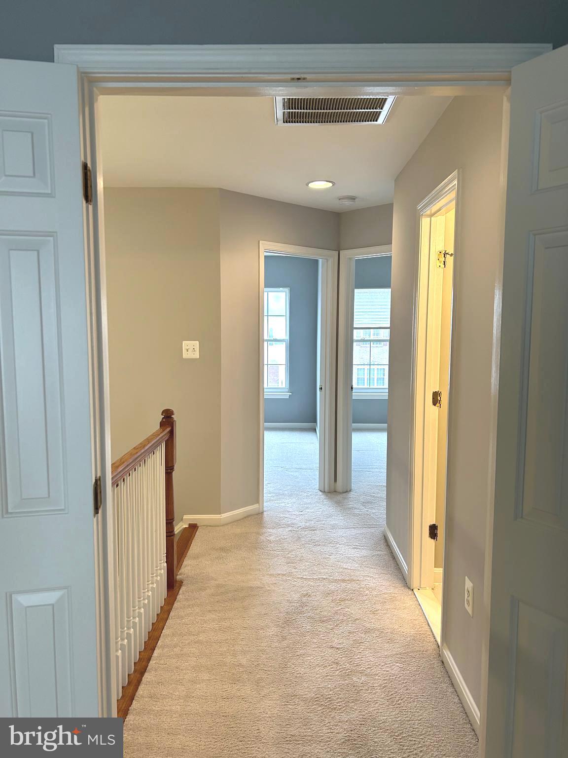 7358 Bloomington Court Springfield, VA 22150 - Photo 26 of 69 a view of a hallway with wooden shelves