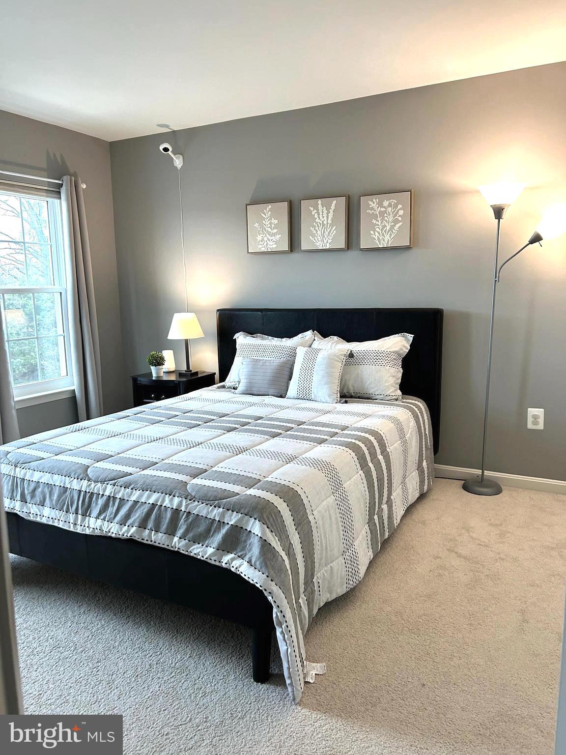 7358 Bloomington Court Springfield, VA 22150 - Photo 28 of 69 a bedroom with a bed and a night stand