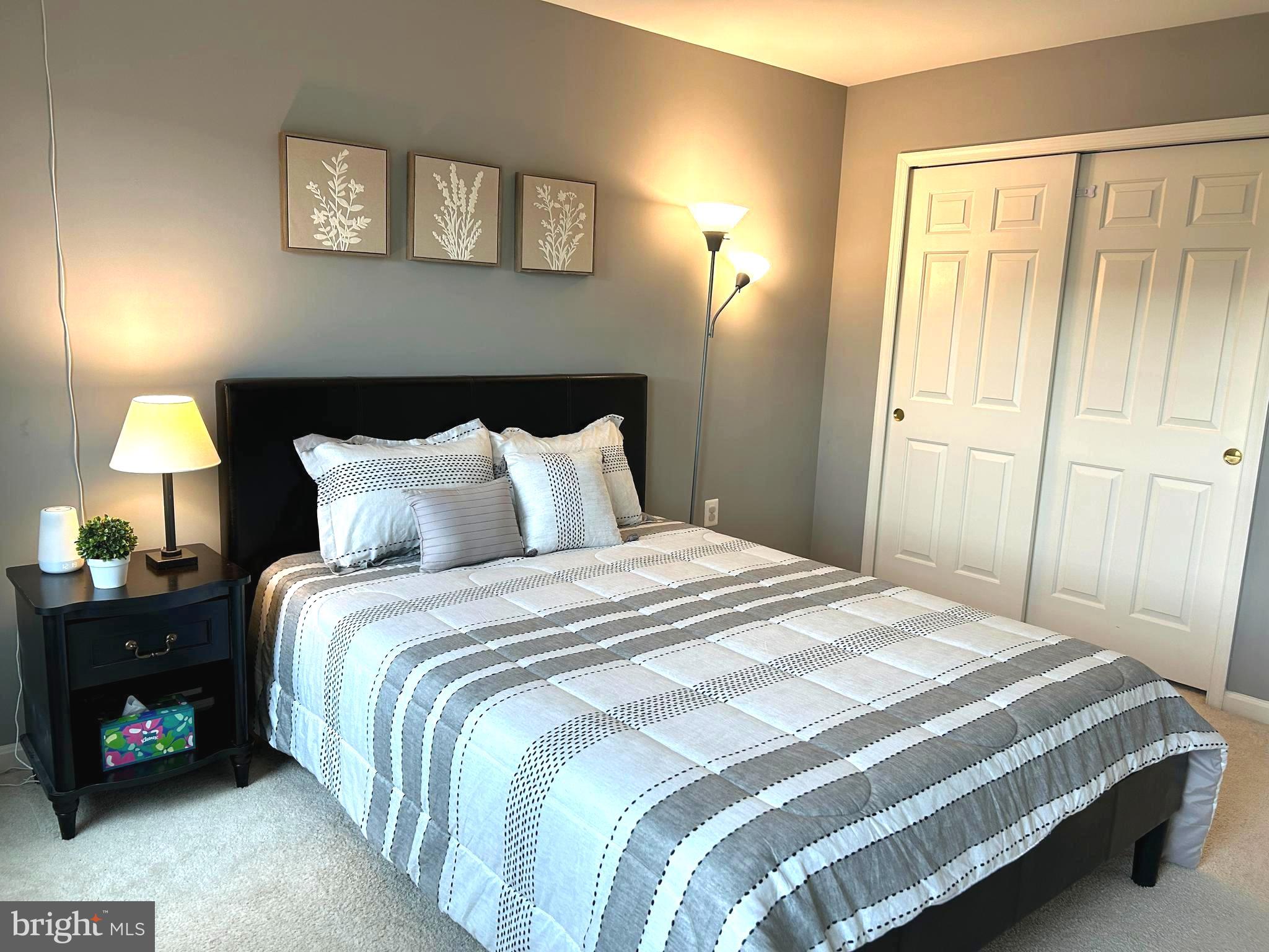 7358 Bloomington Court Springfield, VA 22150 - Photo 29 of 69 a bedroom with a bed and a lamp next to a window