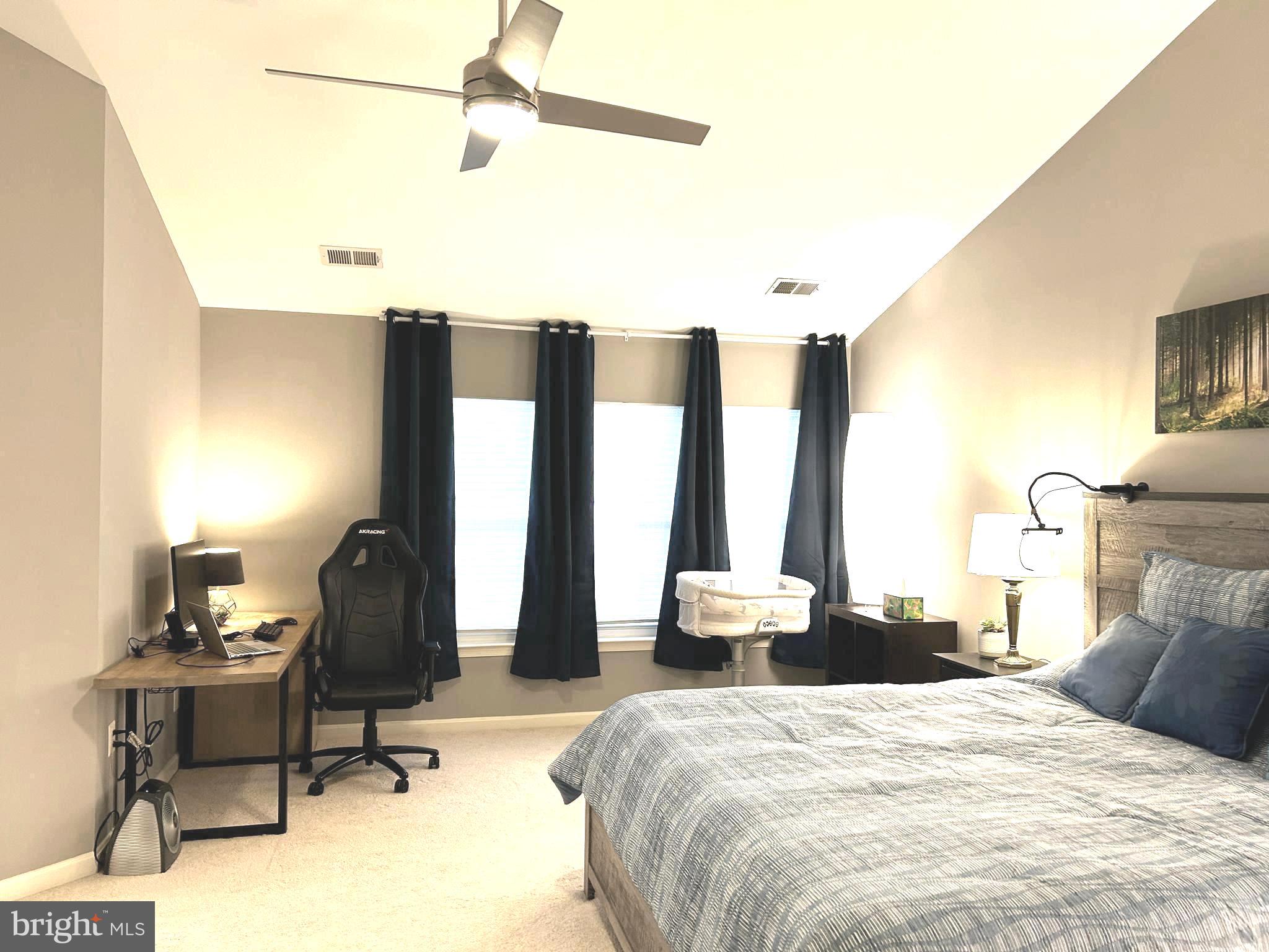 7358 Bloomington Court Springfield, VA 22150 - Photo 31 of 69 a bedroom with a bed a table and chair with the wooden floor