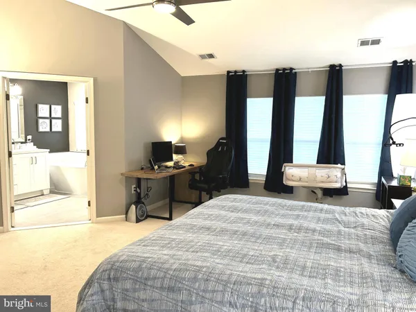 a bedroom with a large bed and a large window