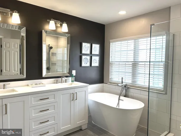a bathroom with a sink vanity and a mirror
