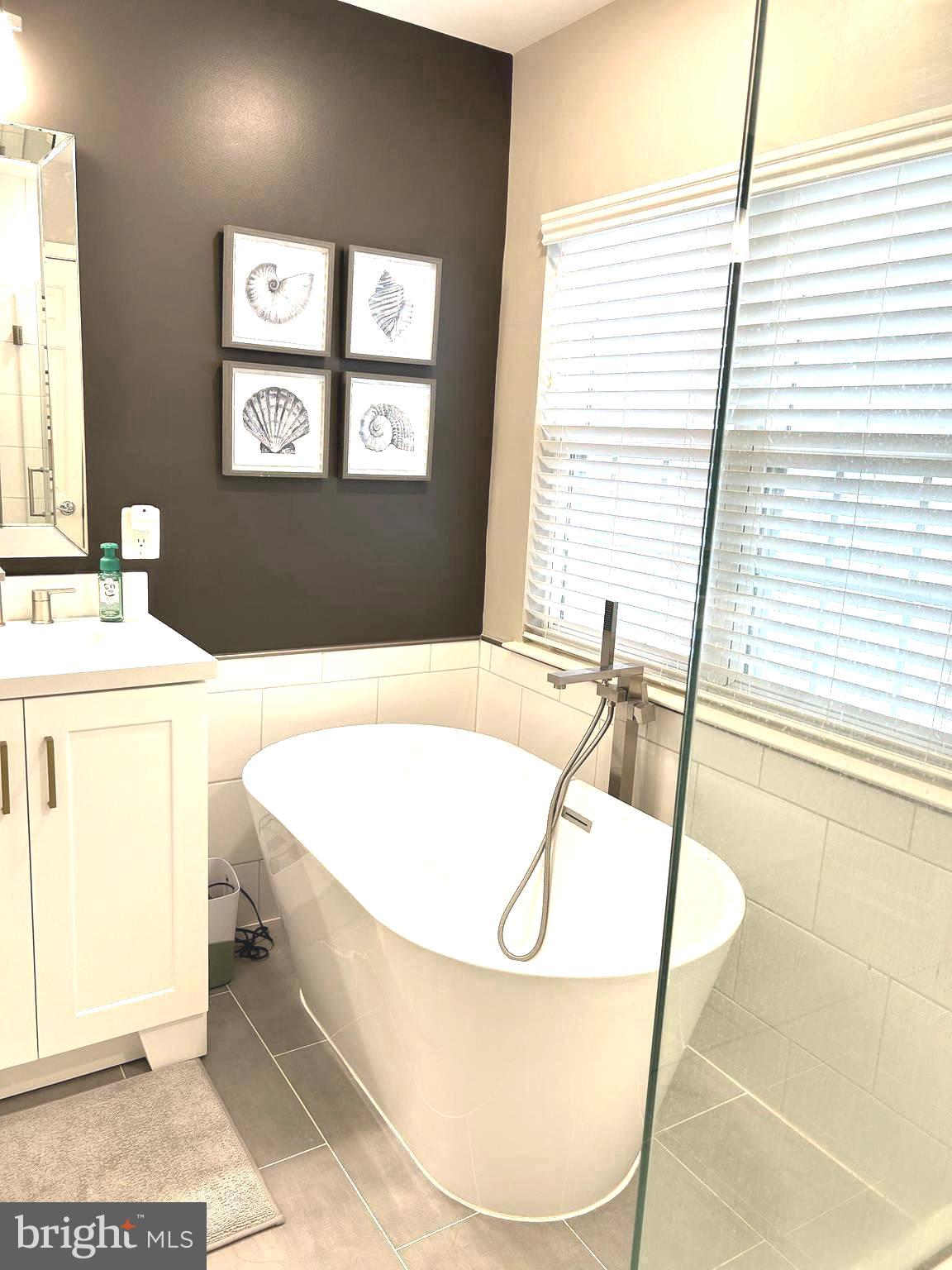 7358 Bloomington Court Springfield, VA 22150 - Photo 38 of 69 a spacious bathroom with a bathtub and next to a window