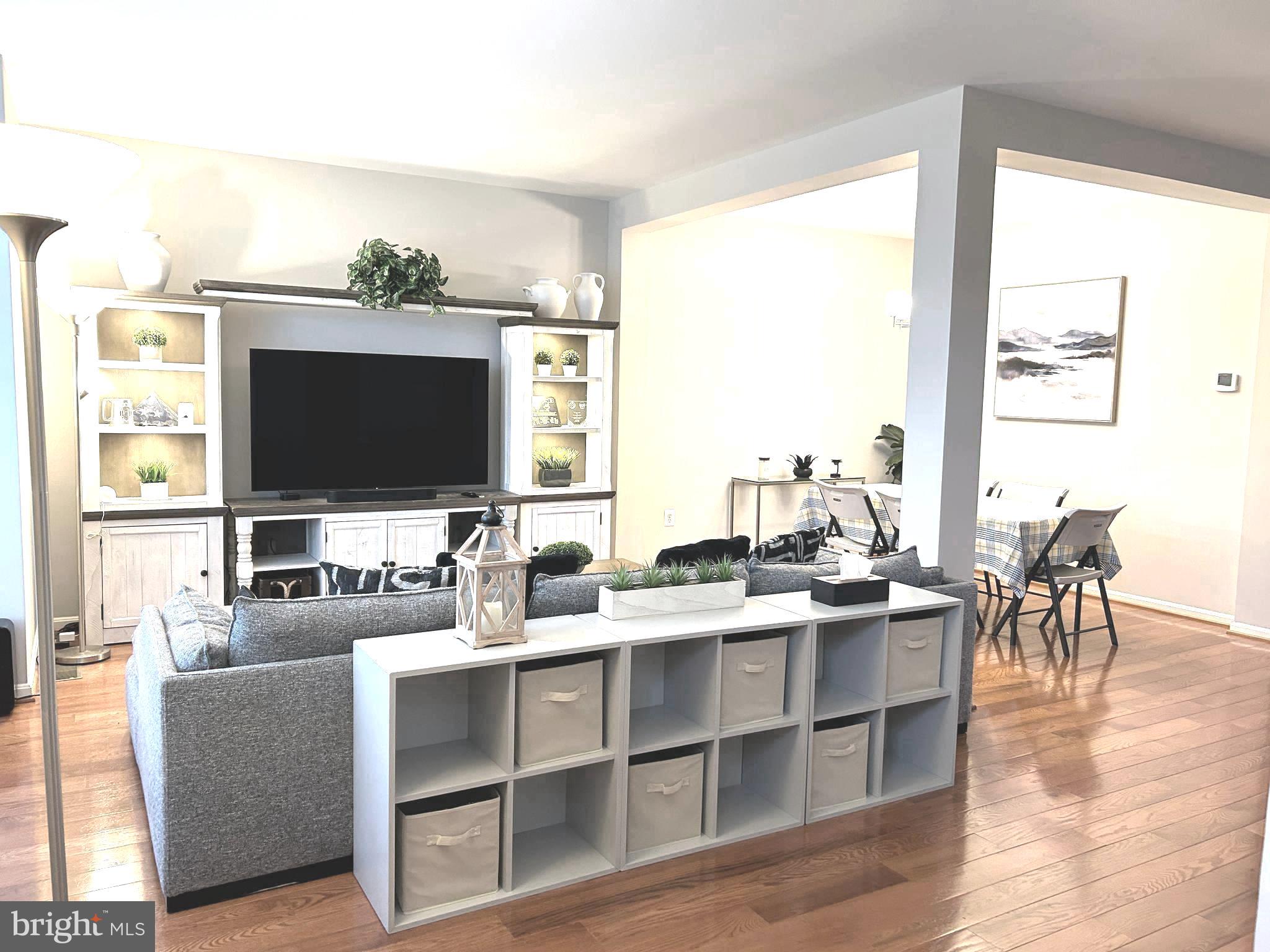 7358 Bloomington Court Springfield, VA 22150 - Photo 4 of 69 a living room with furniture flat screen tv and a large window