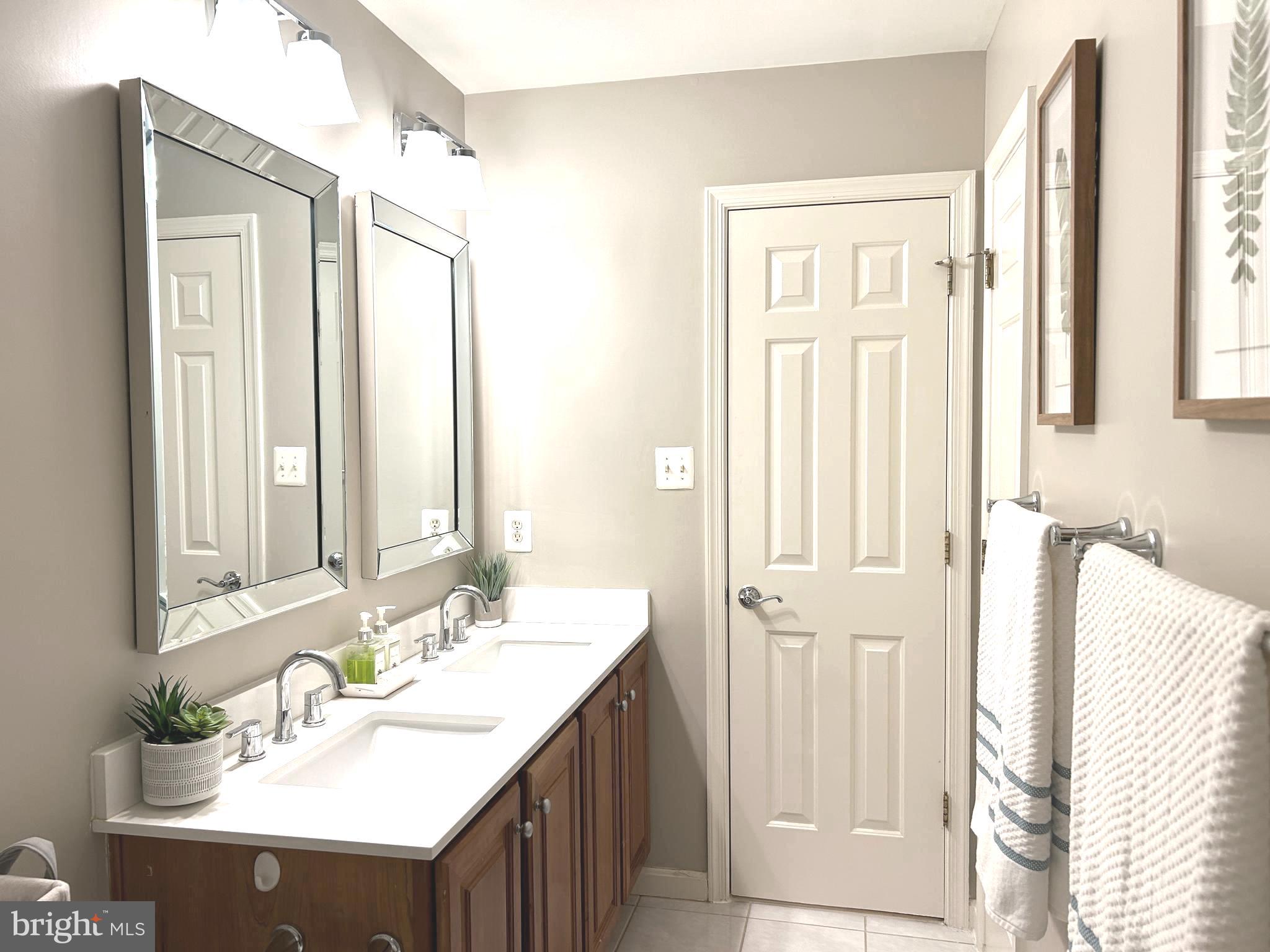 7358 Bloomington Court Springfield, VA 22150 - Photo 48 of 69 a bathroom with a sink vanity and a mirror