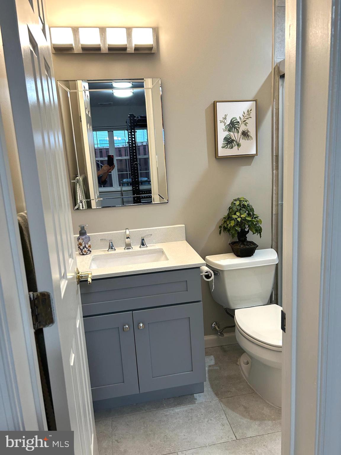 7358 Bloomington Court Springfield, VA 22150 - Photo 63 of 69 a bathroom with a sink mirror vanity and toilet