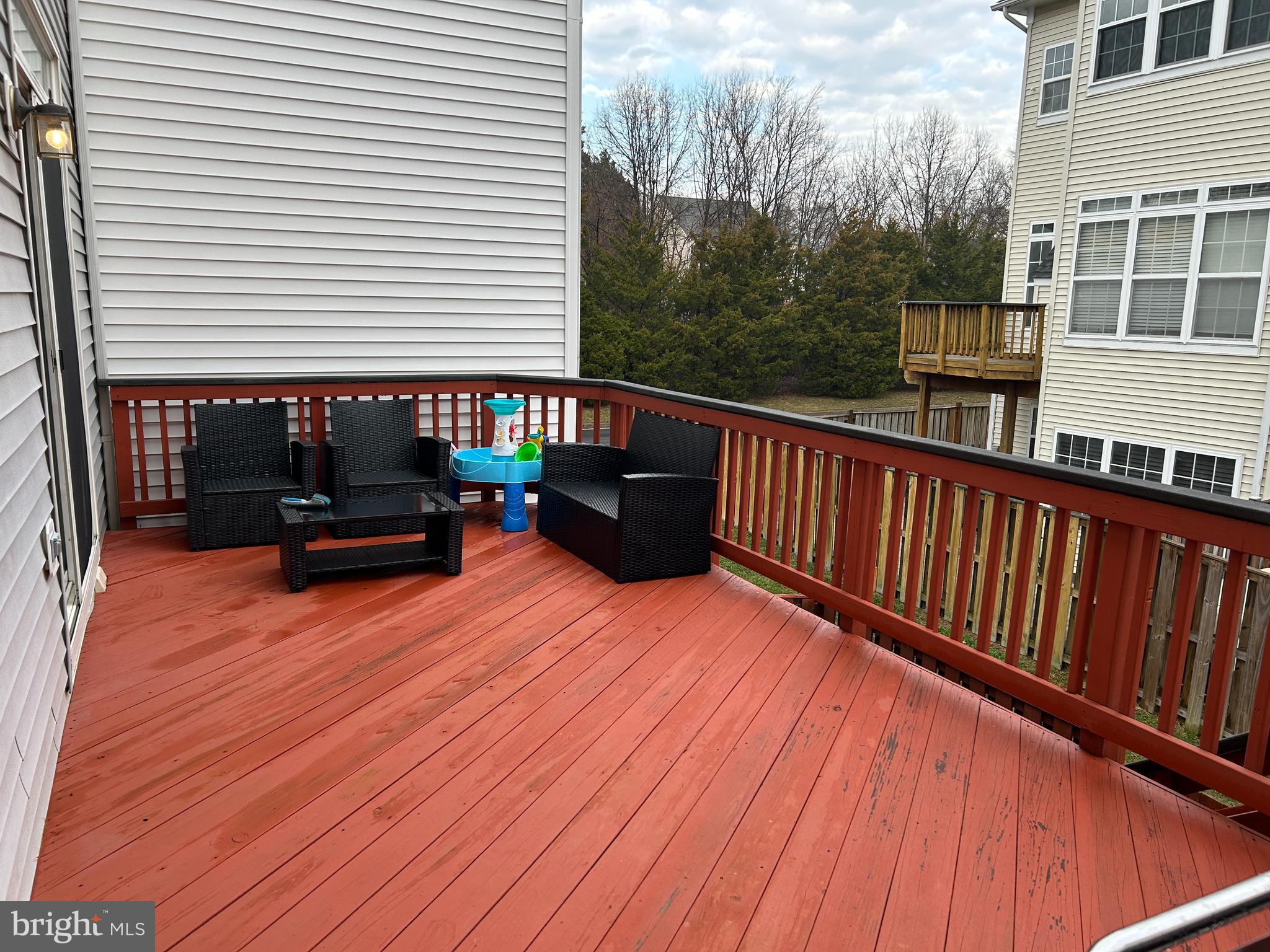 7358 Bloomington Court Springfield, VA 22150 - Photo 65 of 69 a backyard of a house with wooden floor and outdoor seating