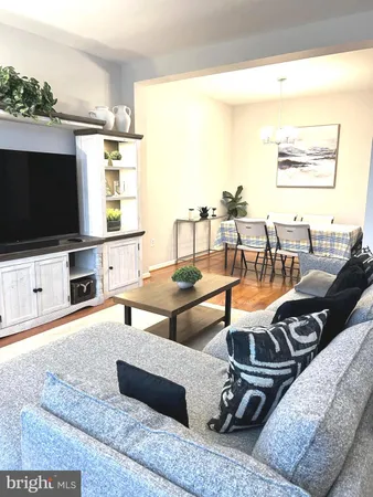 a view of a living room with furniture and a large window