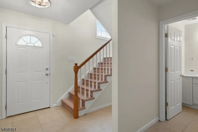 a view of entryway with stairs and windows