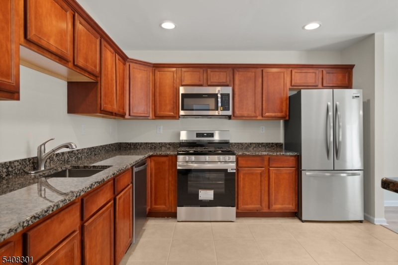 19 Winding Way Hamburg, NJ 07419 - Photo 2 of 16 a kitchen with stainless steel appliances granite countertop a refrigerator stove top oven and sink